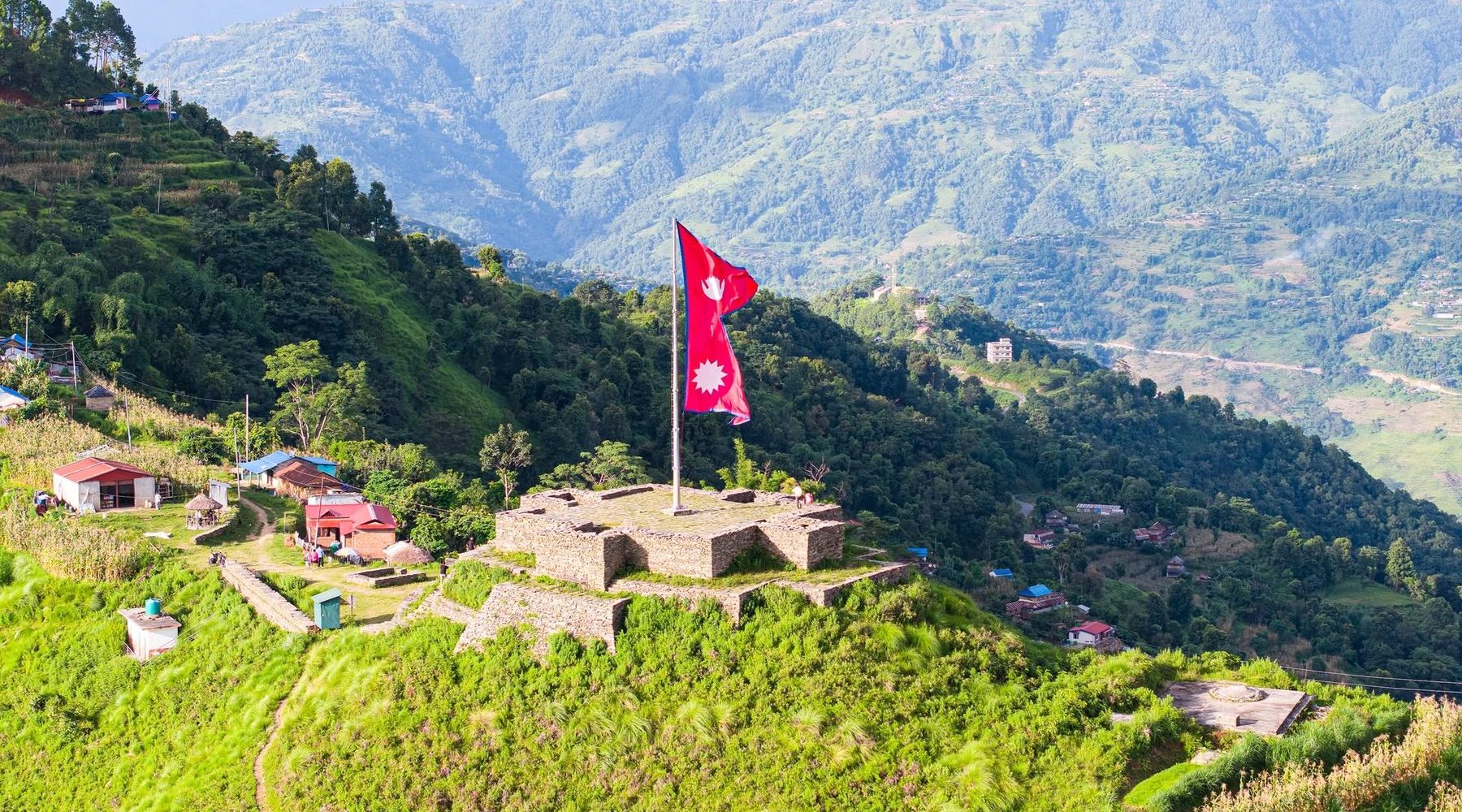 The stone fort at Ligligkot with the national flag flying, above the Palungtar valley in Gorkha
